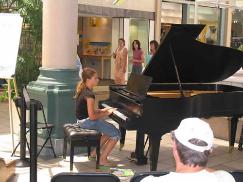 Photo image of piano student getting waiting to perform at the Lakewood Center Mall as part of the Long Beach School of Music Play-a-Thon to raise money for the Piano Fund of the Music Teachers' Association of California Long Beach Branch.